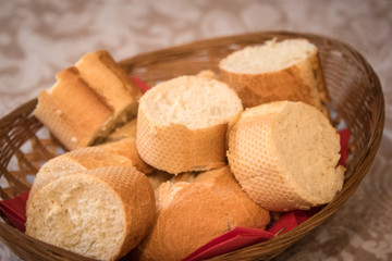 Sliced baguette in bread basket .