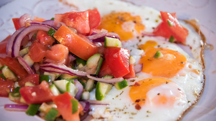Fresh fried eggs served with salad.