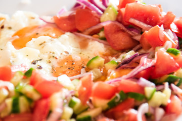 Fresh fried eggs served with salad.