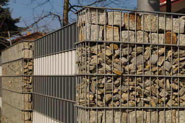 An interesting example of fencing, metal baskets filled with different rock material. Gabions.