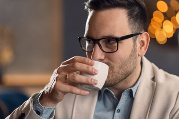 Businessman drinking coffee while relaxing in a cafe