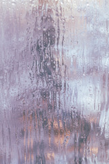 Frozen window in winter with drops and drips