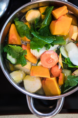 Vegan soup preparation, step 6 - Putting the veggies in the pot.