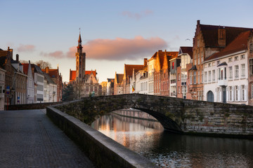 Naklejka premium Brugge evening cityscape. Old buildings at water channel in Bruges, Belgium