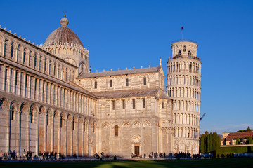 Fototapeta na wymiar Pisa,tuscany/Italy 23 february 2019 :the Cathedral of Pisa and the legendary leaning tower in a bright but cold sunny day
