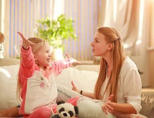 Young mother and daughter are having fun playing at home, happy parenting and family leisure