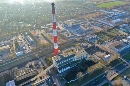 Heating plant with high chimney in city area, aerial view.