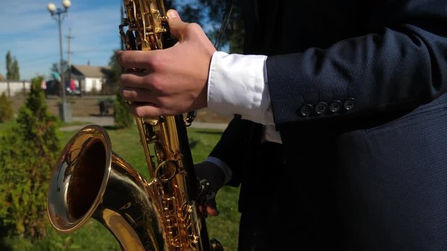 man playing saxophone jazz music. Saxophonist in dinner jacket play on golden saxophone. Live performance.