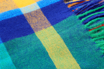 Texture of a bright multicolor scarf with fringe