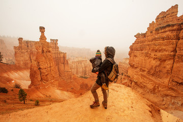 Fototapeta na wymiar Mother with son are hiking in Bryce canyon National Park, Utah, USA