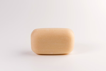 piece of beige soap isolated on a white background