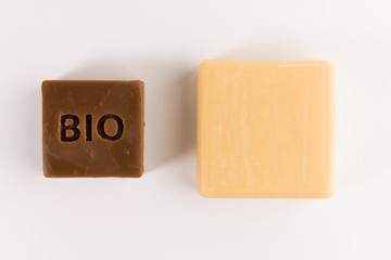 two pieces of natural soap isolated on a white background, top view