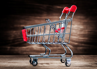 shopping cart on wood close up view