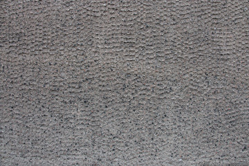Ribbed concrete wall closeup photo. Gray cement surface with fluted texture.