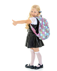 Little girl holding her thumb up