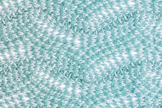 Texture knitting with an unusual pattern. Wool fabric close up. Background for layouts.