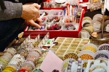 A woman chooses jewelry with precious stones in a jewelry store