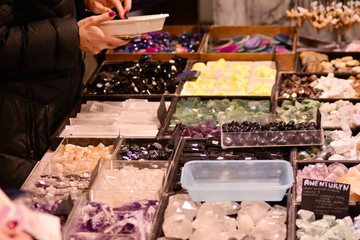 A woman chooses jewelry with precious stones in a jewelry store