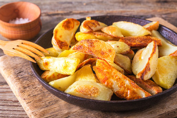 Crisp golden deep fried, french fries hot potatoes, frying and ready to be eaten, really yummy. Fried potatoes in the old cast-iron pan