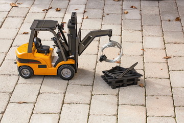 Fototapeta na wymiar View of radio controlled model forklift. Free time Children and adults concept. Hobby. Toys. 