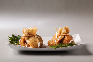 Pancakes with meat, herbs and sour cream - traditional for Russian pancake week Maslenitsa. Happy Shrove Tuesday