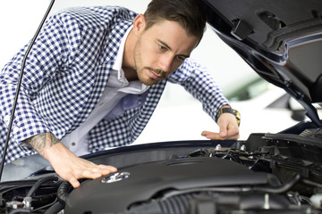 Handsome young man buying a car