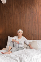 Mature woman sitting on a bed