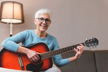 Mature woman playing guitar