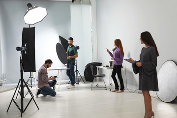 Fototapeta premium Photo studio with professional equipment and team of workers