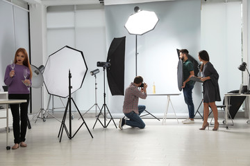 Photo studio with professional equipment and team of workers