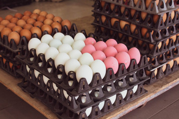 white and pink eggs in a tray