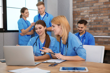 Medical students in uniforms studying at university