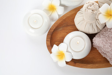 Beautiful spa composition with candles and flowers on white background, top view