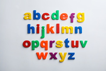 Plastic magnetic letters isolated on white, top view. Alphabetical order