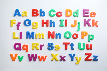 Plastic magnetic letters isolated on white, top view. Alphabetical order - obrazy, fototapety, plakaty