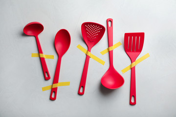 Set of clean kitchen utensils on grey background, flat lay