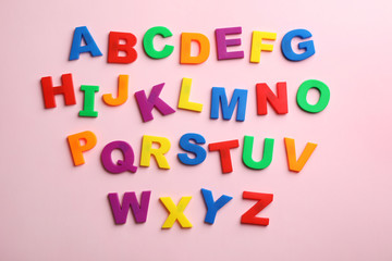 Plastic magnetic letters on color background, top view. Alphabetical order