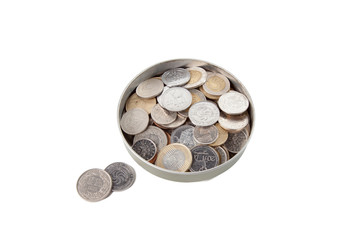 A can with coins of different countries, two of which have fallen out of the can, on a white isolated background