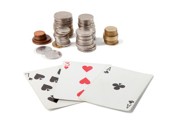 Three playing cards with 21 points and columns of coins from different countries on an isolated white layer