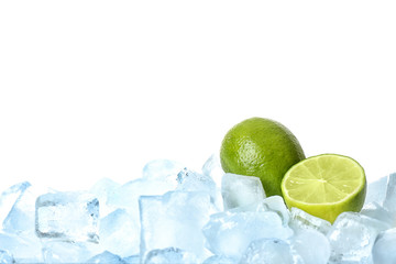 Fresh limes on ice cubes against white background