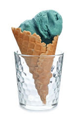 Spirulina ice cream cone in glass on white background
