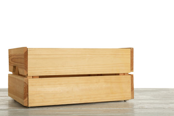 Empty rustic wooden crate on table against white background