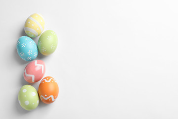 Fototapeta na wymiar Beautiful painted Easter eggs on white background, top view