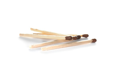 Several whole wooden matches on white background