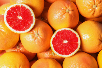 Many whole fresh ripe grapefruits as background, top view