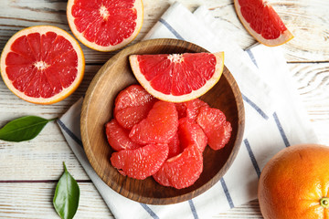 Flat lay composition with grapefruits on wooden background