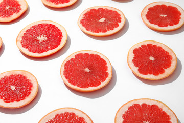 Fresh sliced ripe grapefruits on white background