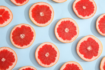 Fresh sliced ripe grapefruit on color background, flat lay