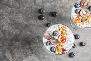 Tasty chia seed pudding with granola served on table, flat lay. Space for text
