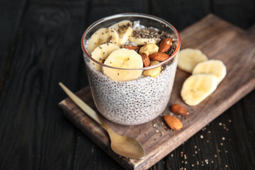 Dessert bowl of tasty chia seed pudding with banana and nuts served on table